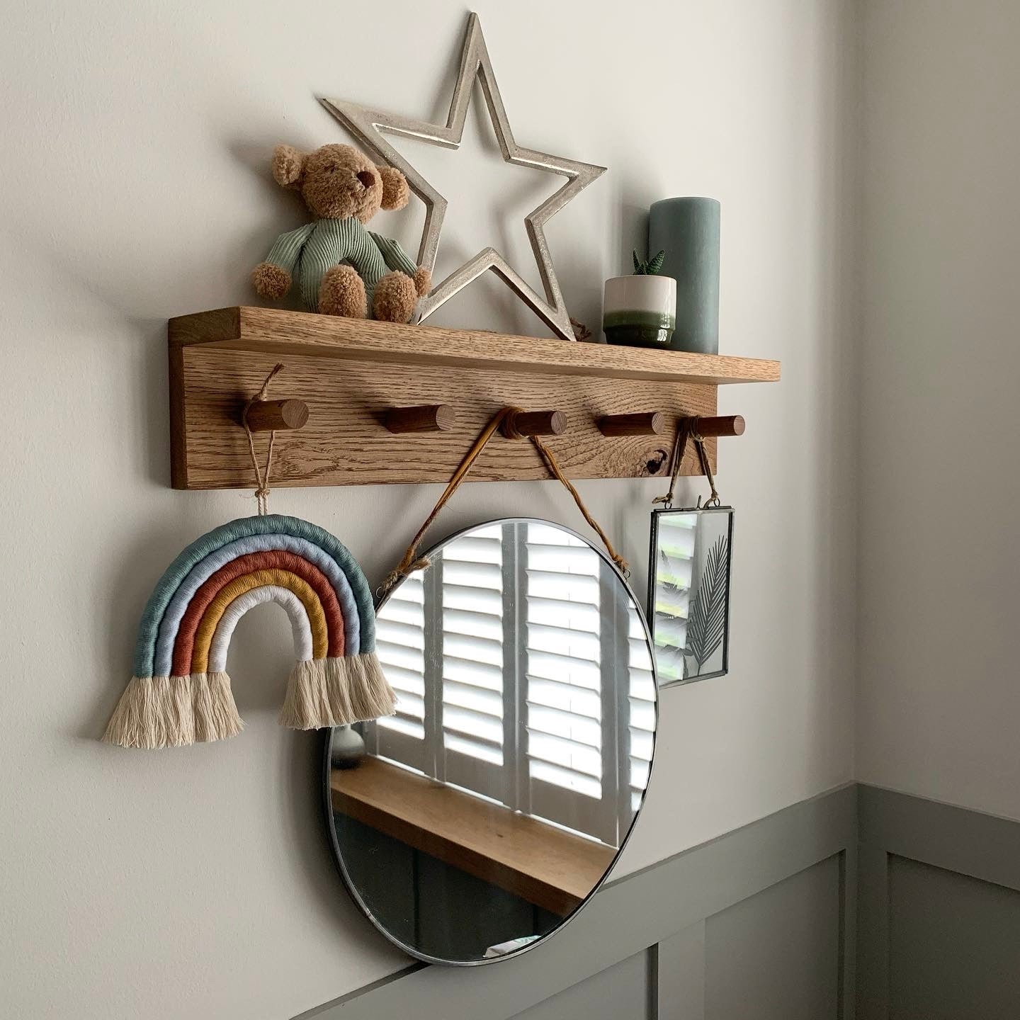 Handmade solid oak shaker peg shelf with a natural oil finish, wall-mounted against a plain white wall, showing a clean top ledge and sturdy pegs.