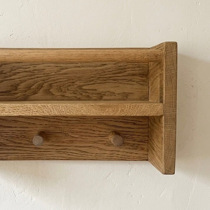 Wooden drawer with two knobs on a light background