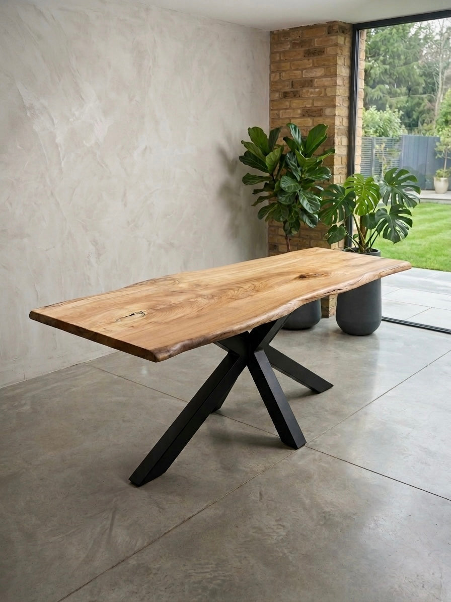 Wooden dining table with black metal legs in an outdoor setting